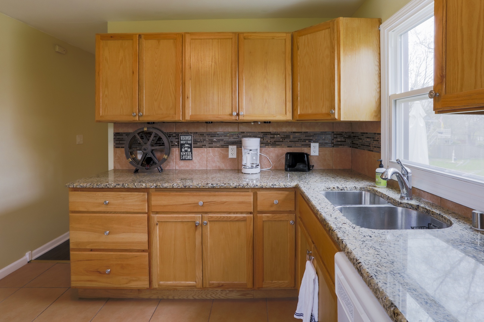 The cozy kitchen is well-equipped and offers ample storage/counter space