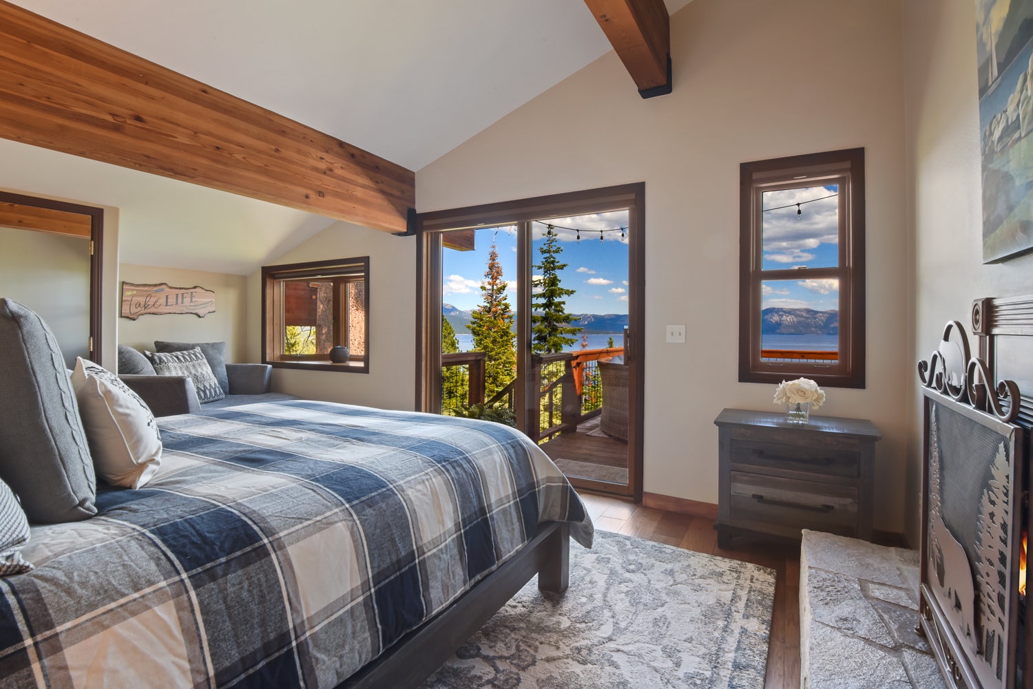 Master bedroom: Queen bed with fireplace and balcony access