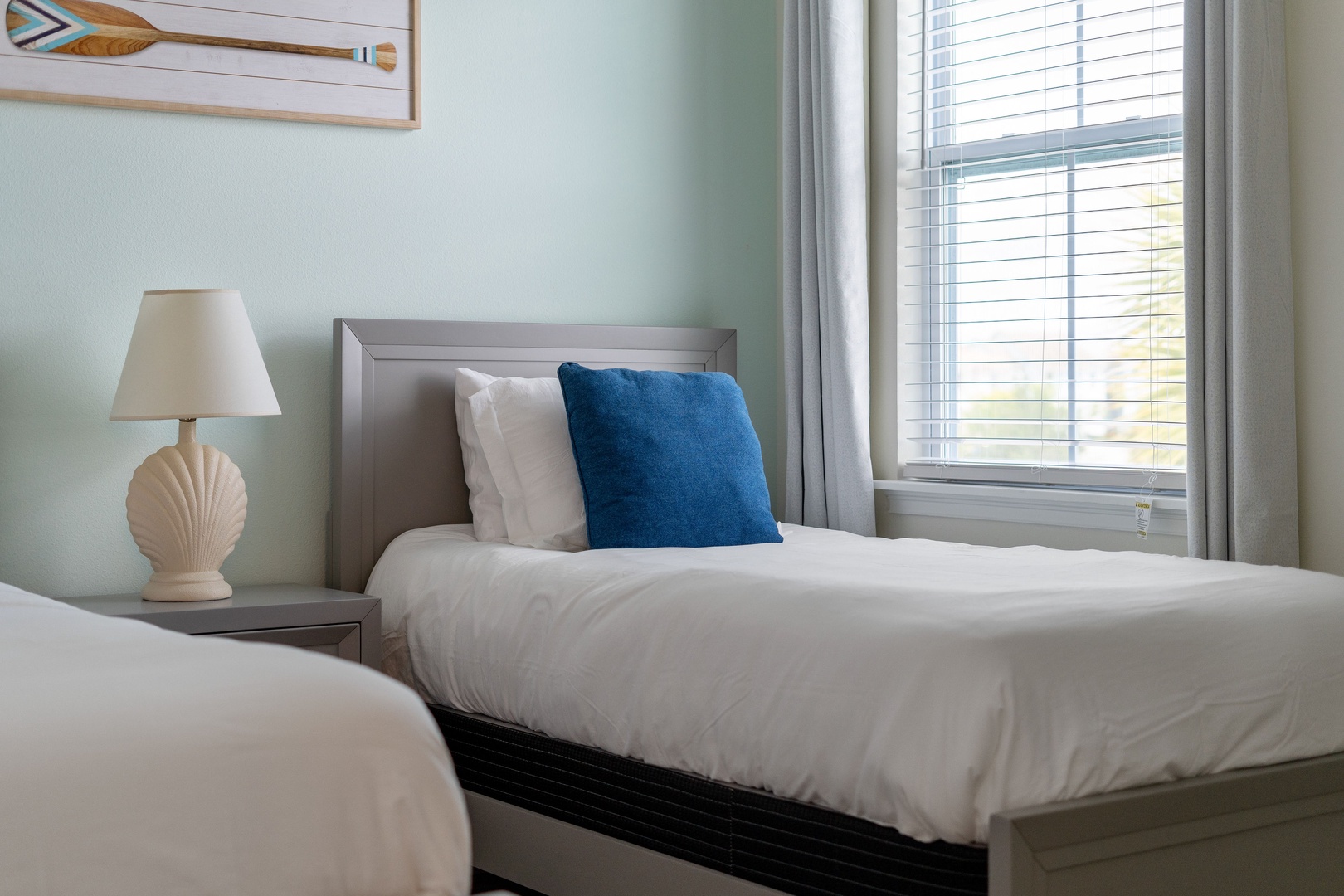 Smart TV & cozy twin beds nestled by the window, a perfect spot for lounging