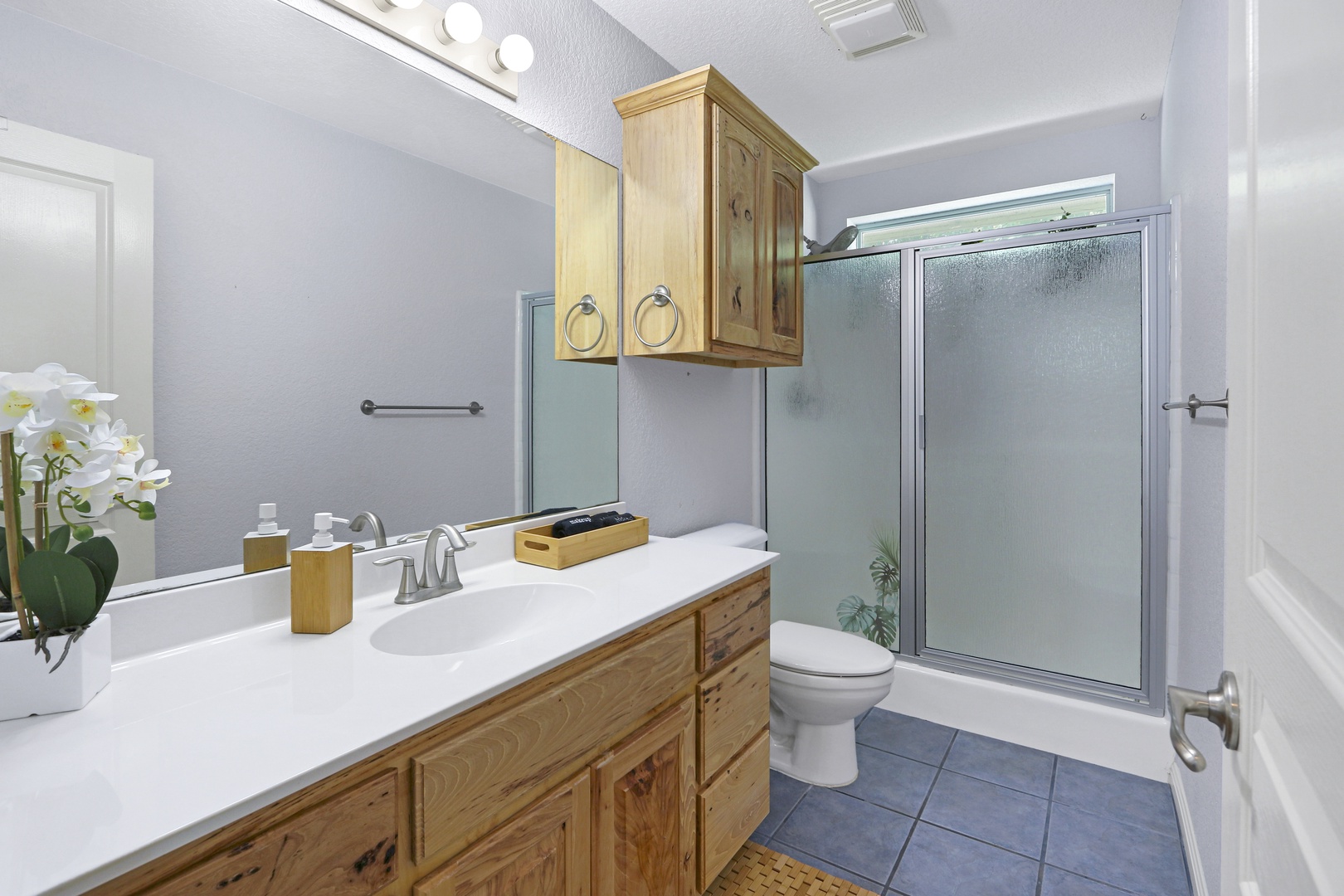 2 of 2 spacious full bathrooms, with an oversized vanity & glass shower