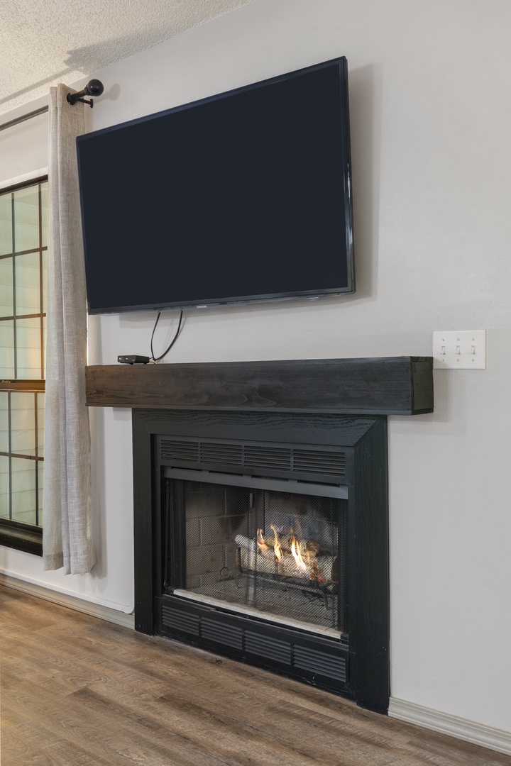 Living room features SmartTV and fireplace
