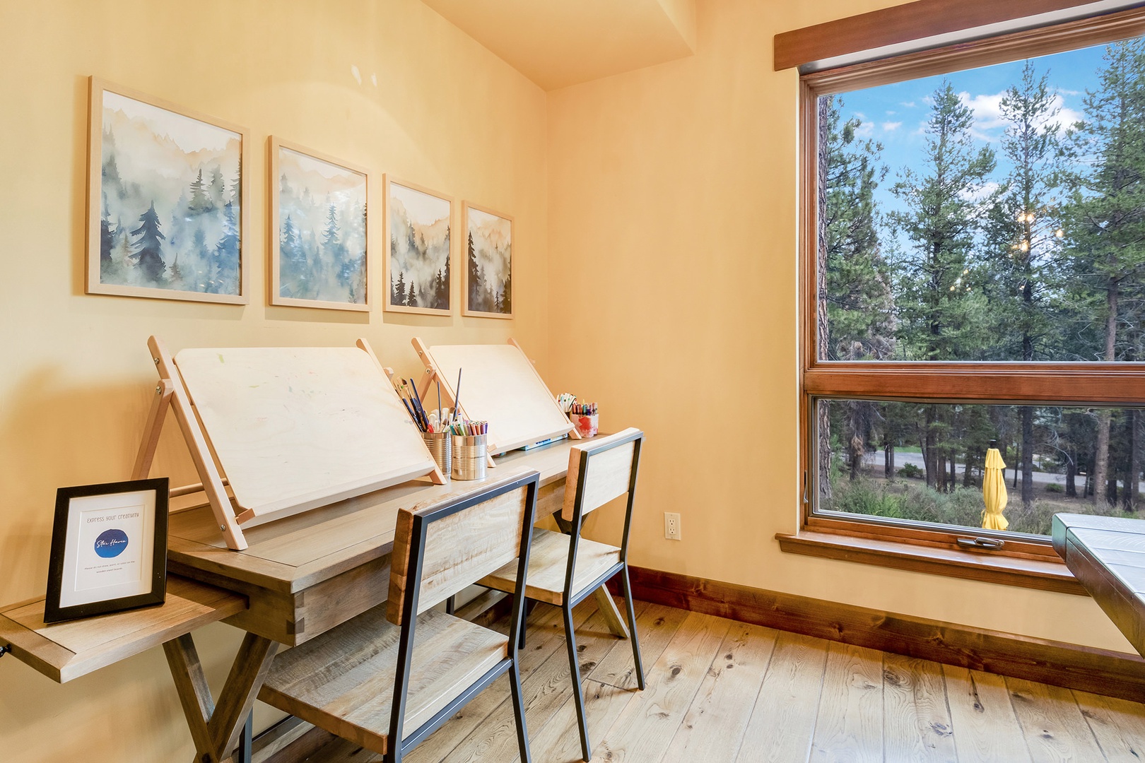 Dining area with multiple tables with seating, and paint station