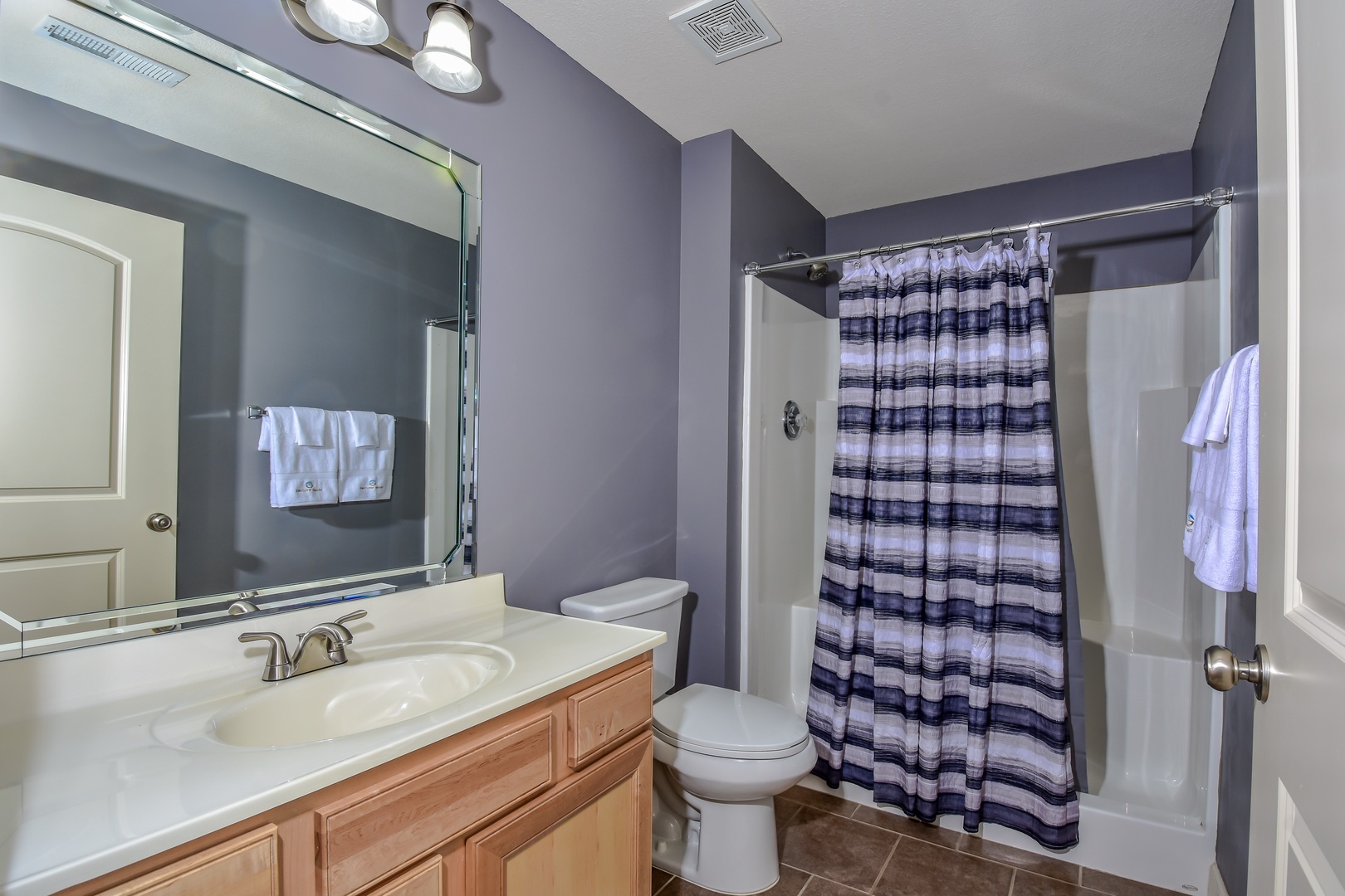 The master ensuite features a single vanity & walk-in shower
