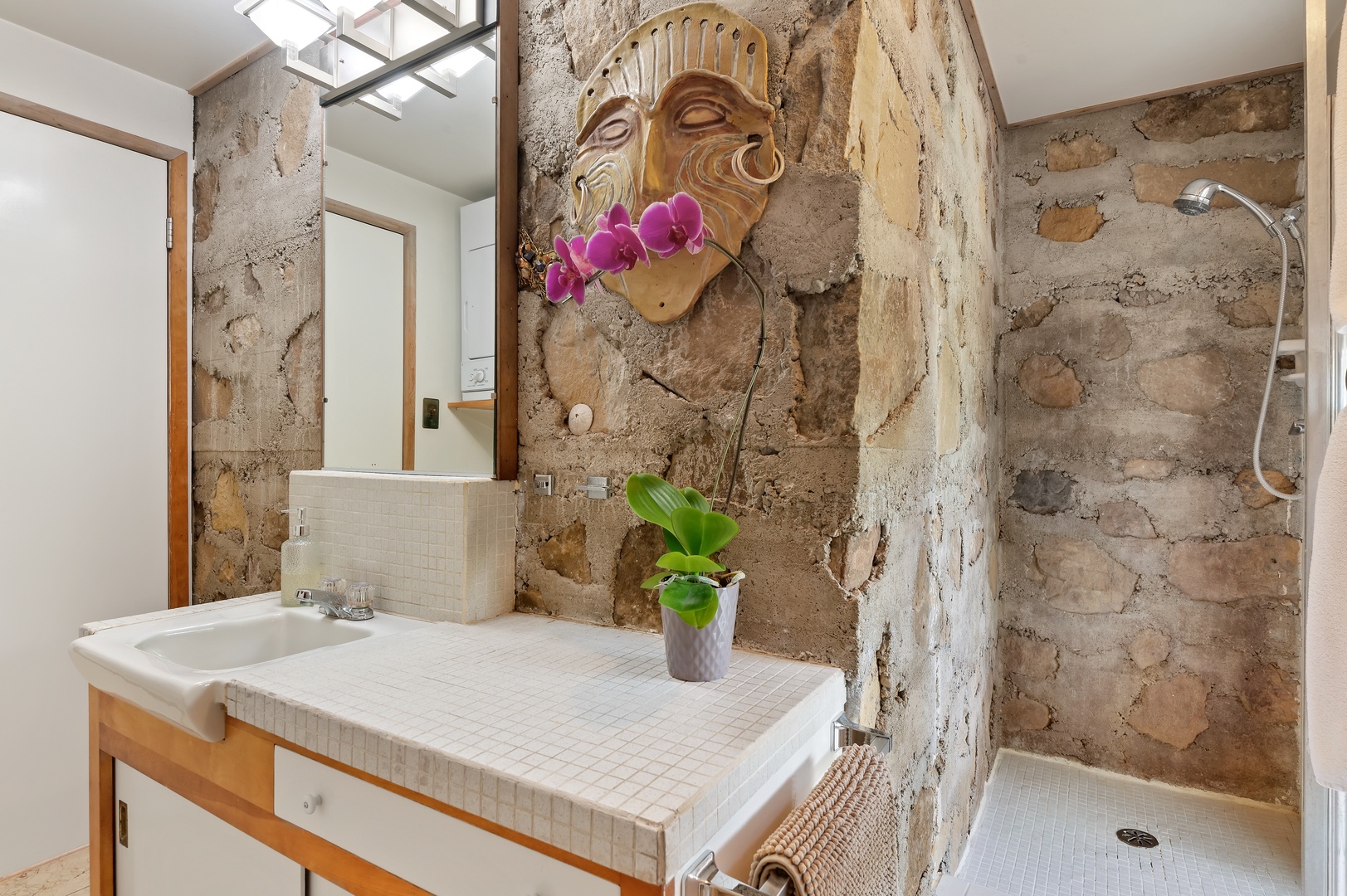 First Floor Bathroom with natural stone details, ample counter space, and Shower