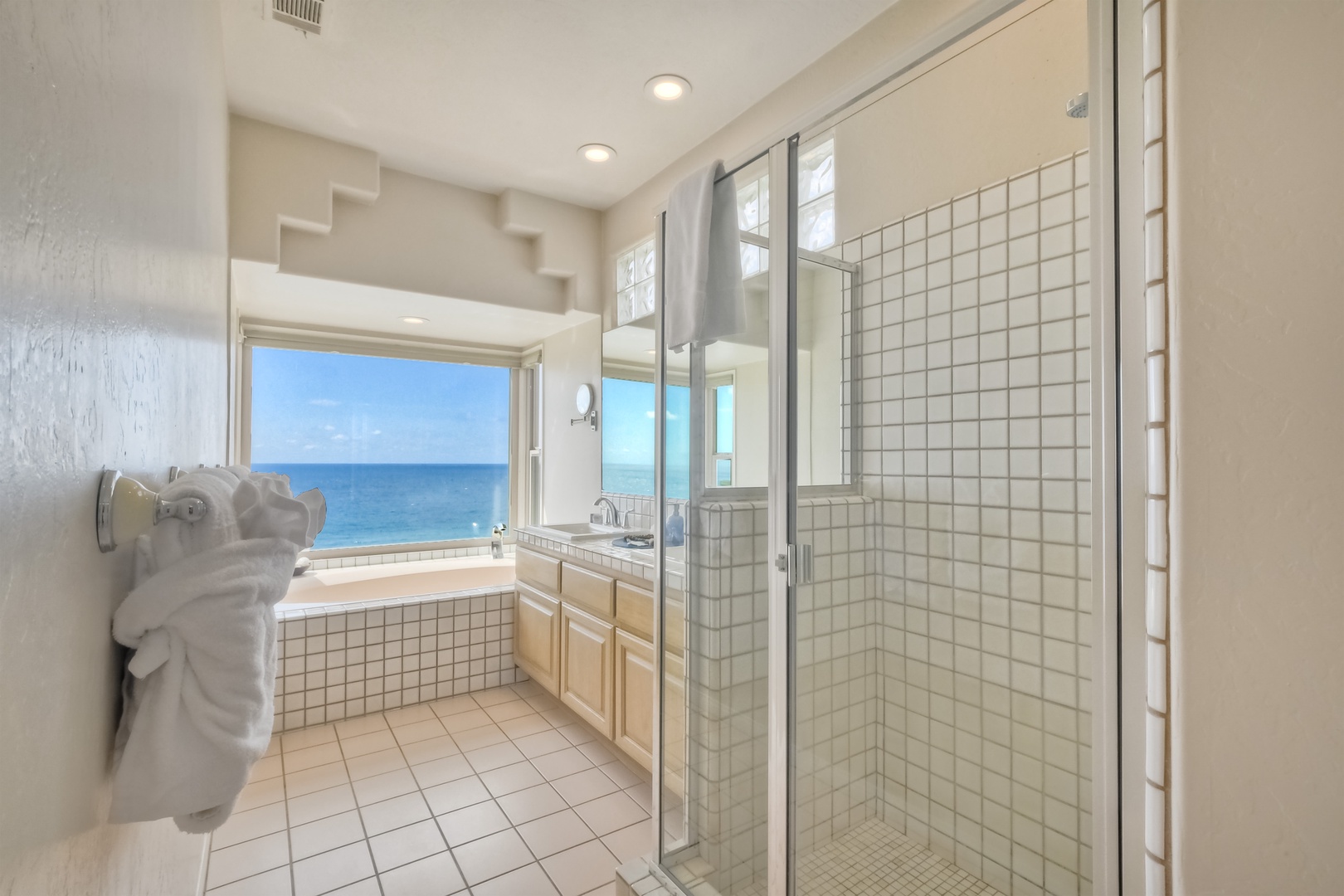 The king ensuite offers a double vanity, glass shower, & soaking tub