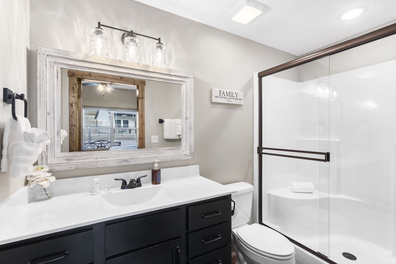 The first bedroom’s ensuite includes a single vanity & glass shower