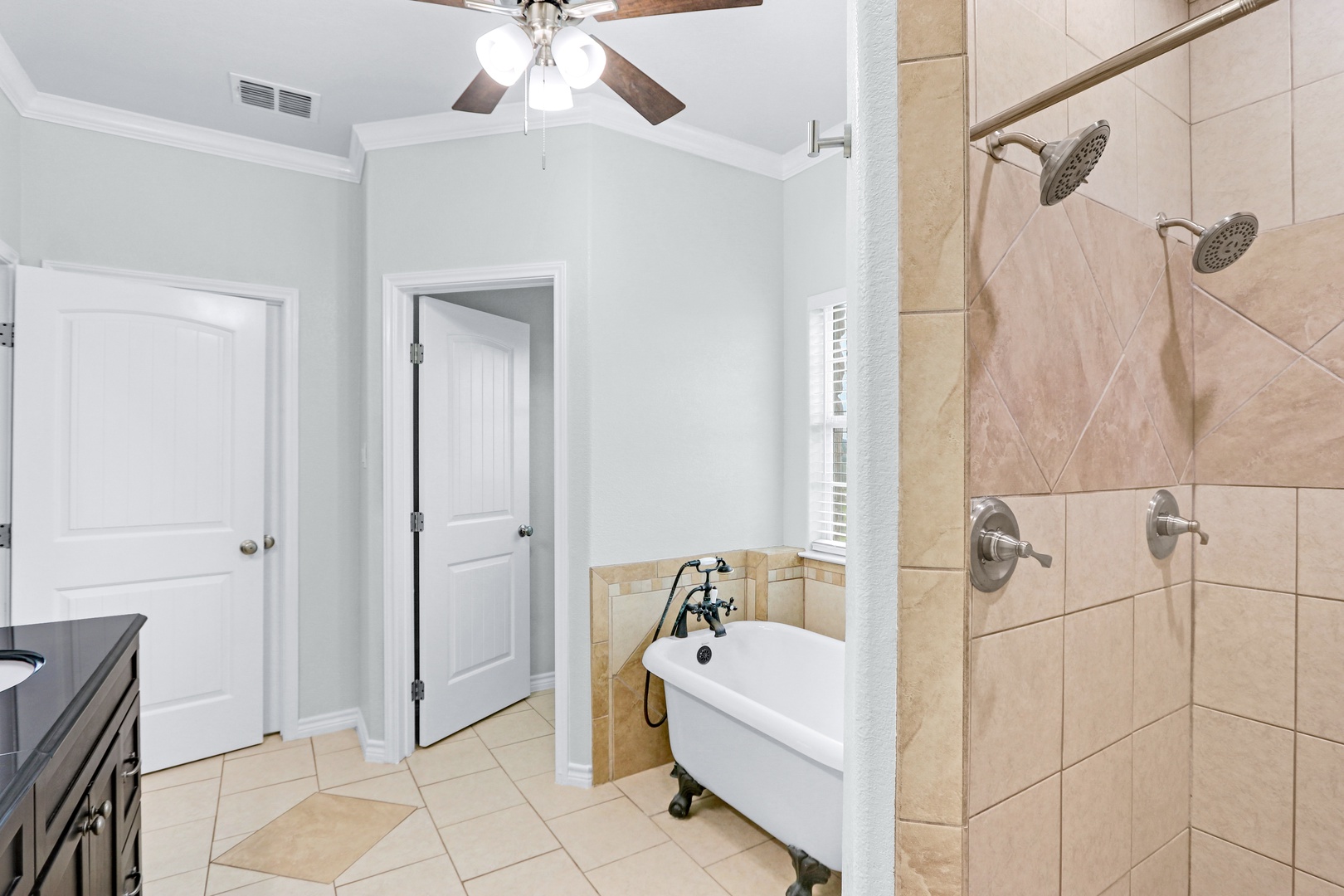 The king ensuite showcases a double vanity, walk-in shower, & soaking tub