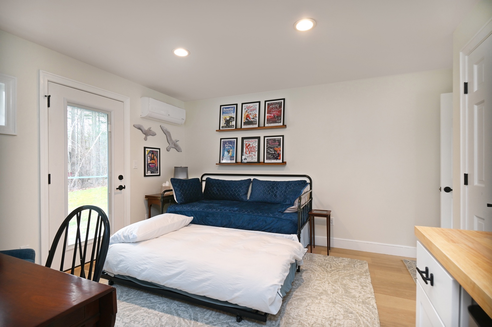 A twin daybed with twin trundle, Smart TV, & kitchenette await in this serene bedroom