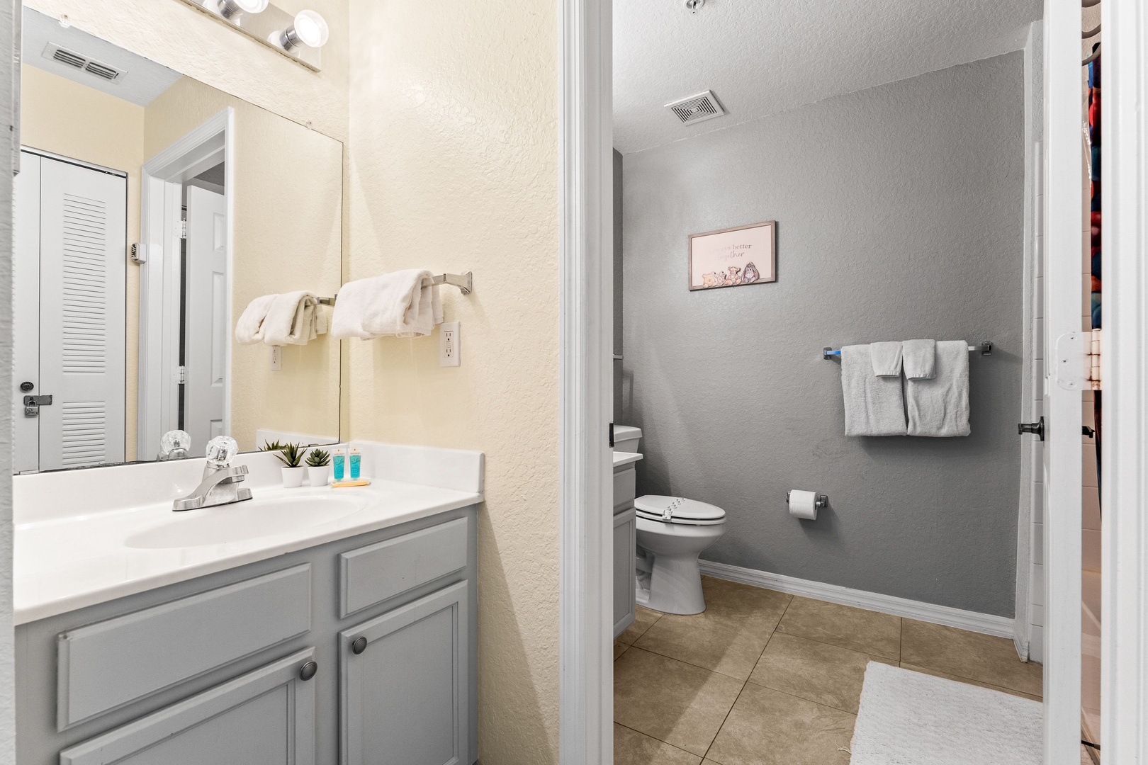 Shared bathroom w/ shower/tub combo & an additional separate vanity area