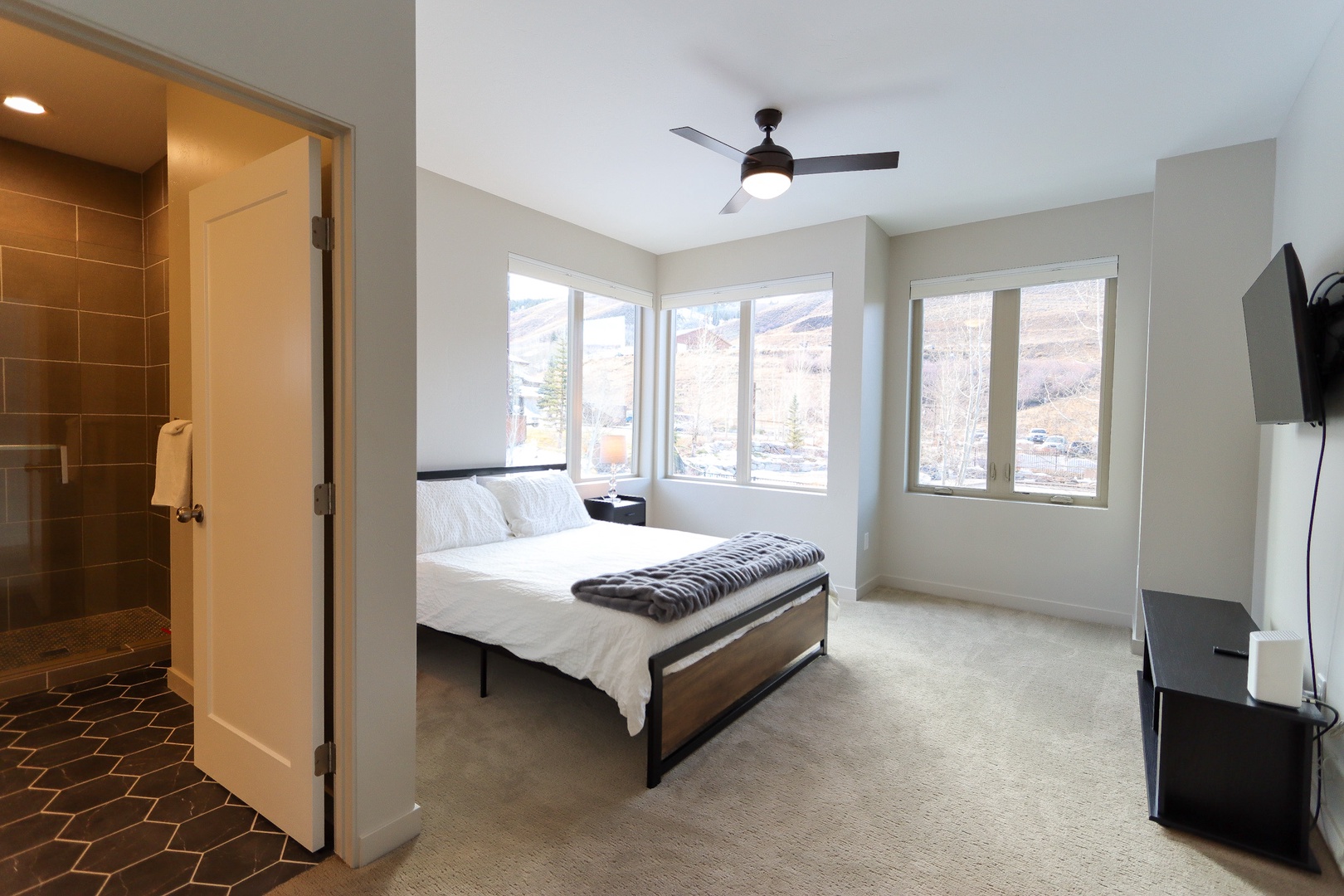 Bedroom 1 with Queen bed, Smart TV, and en-suite