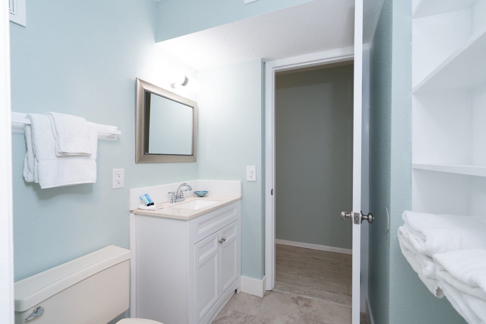 The home’s full bath features a single vanity & shower/tub combo