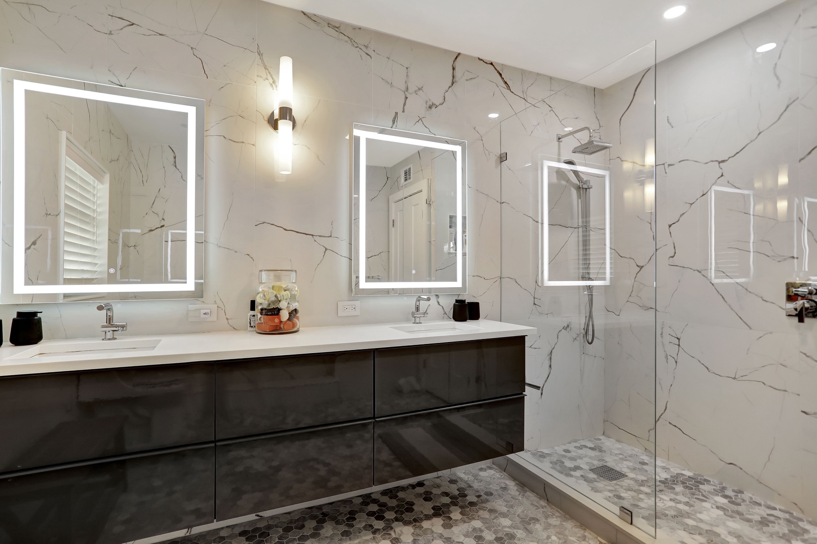 High-end finishes await in this spacious ensuite, offering a luxe glass shower