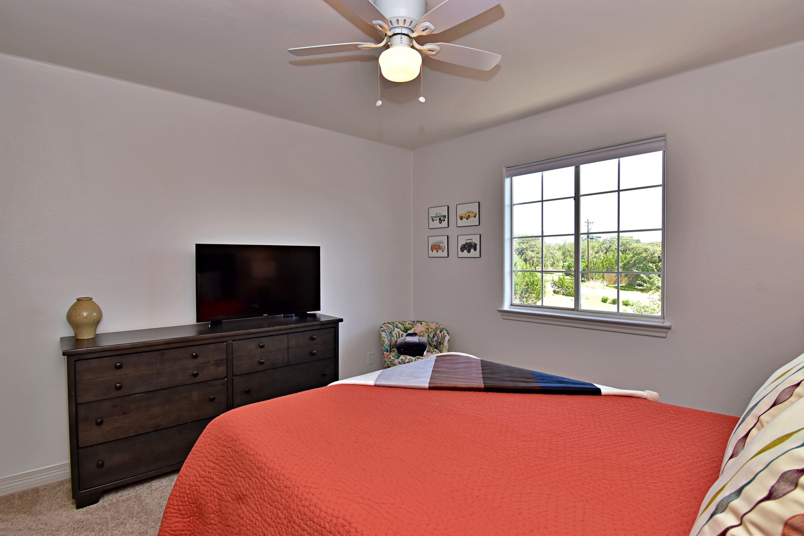 The second bedroom retreat features a plush queen bed & Smart TV