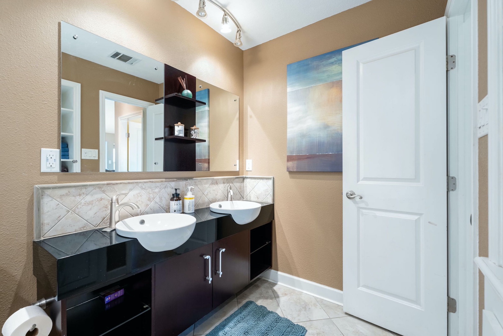 A chic dual vanity & shower/soaking tub combo await in the full bath