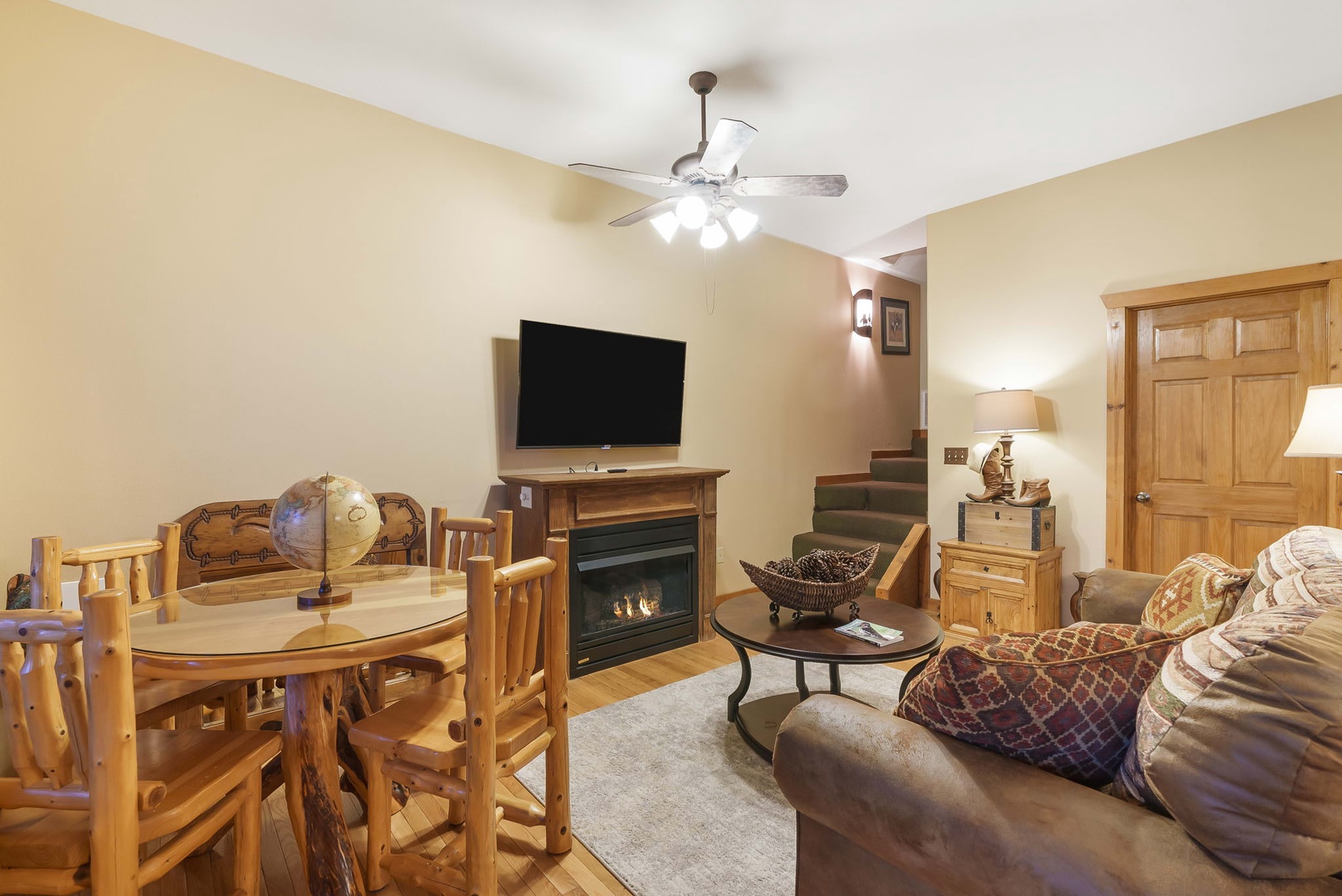 Lower floor living area with Smart TV, fireplace, 2 Twin beds, bathroom, and back deck access