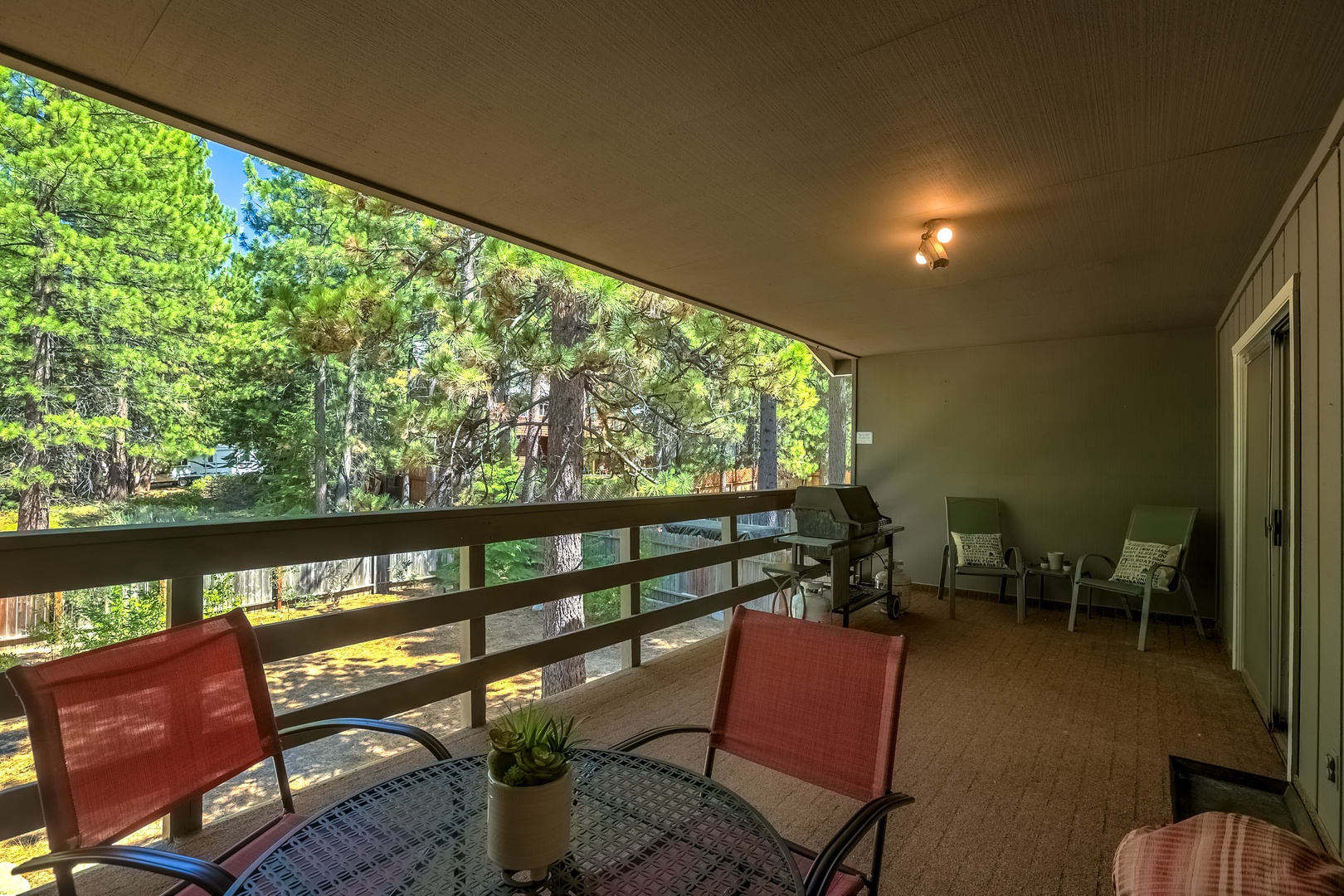 Lower balcony with BBQ and patio furniture