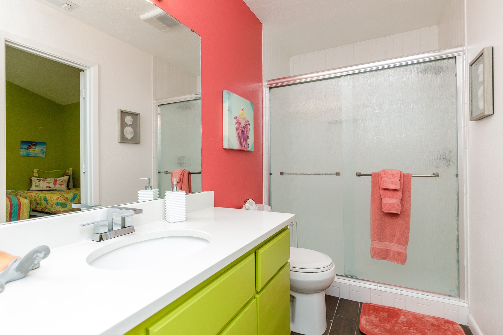 The queen en suite offers a colorful single vanity & glass shower