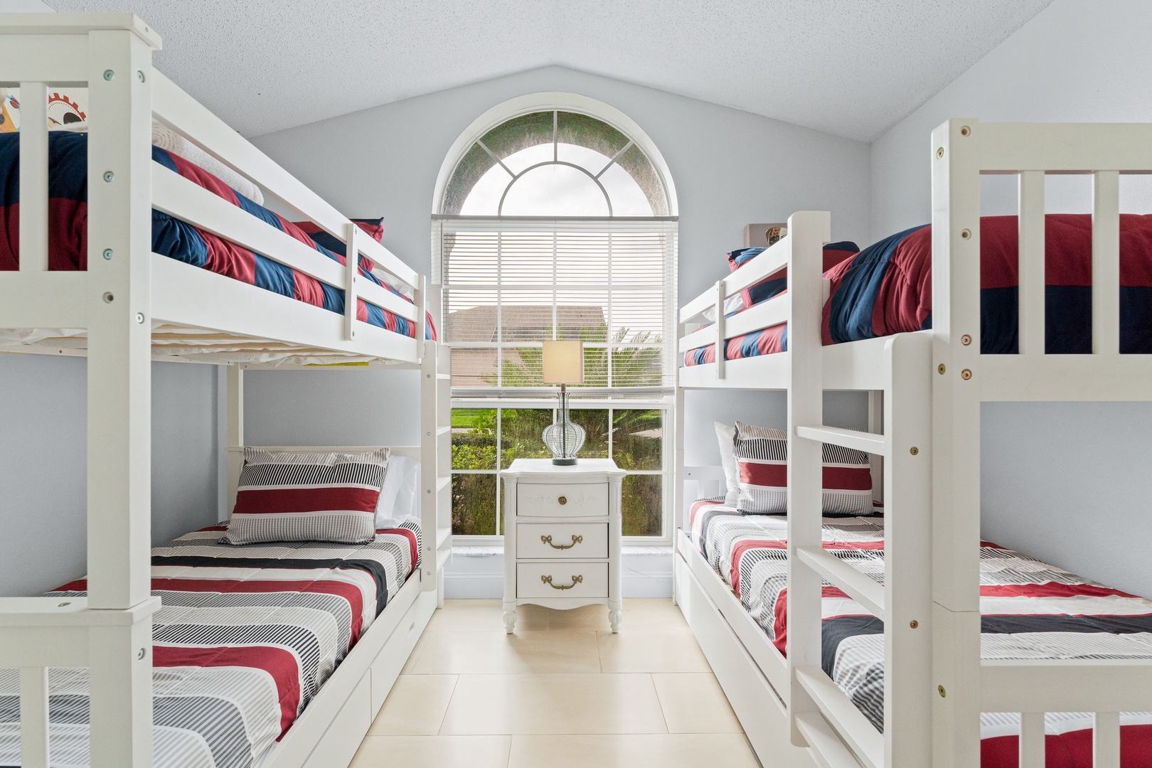 Rest easy in this cozy bedroom with twin beds and a trundle.