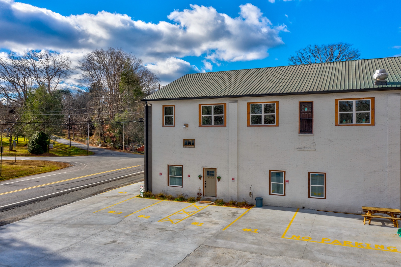 There are 2 designated parking spaces right next to the building and side entrance