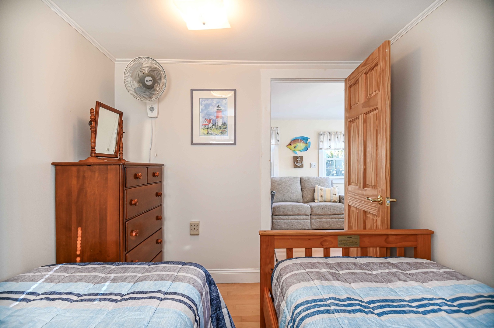 A pair of twin beds & large dresser awaits in the second bedroom