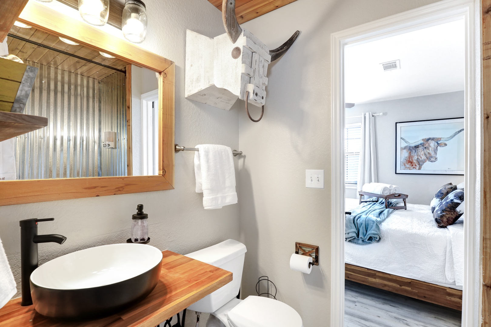 The upstairs Jack & Jill bathroom includes a chic vanity & shower/tub combo