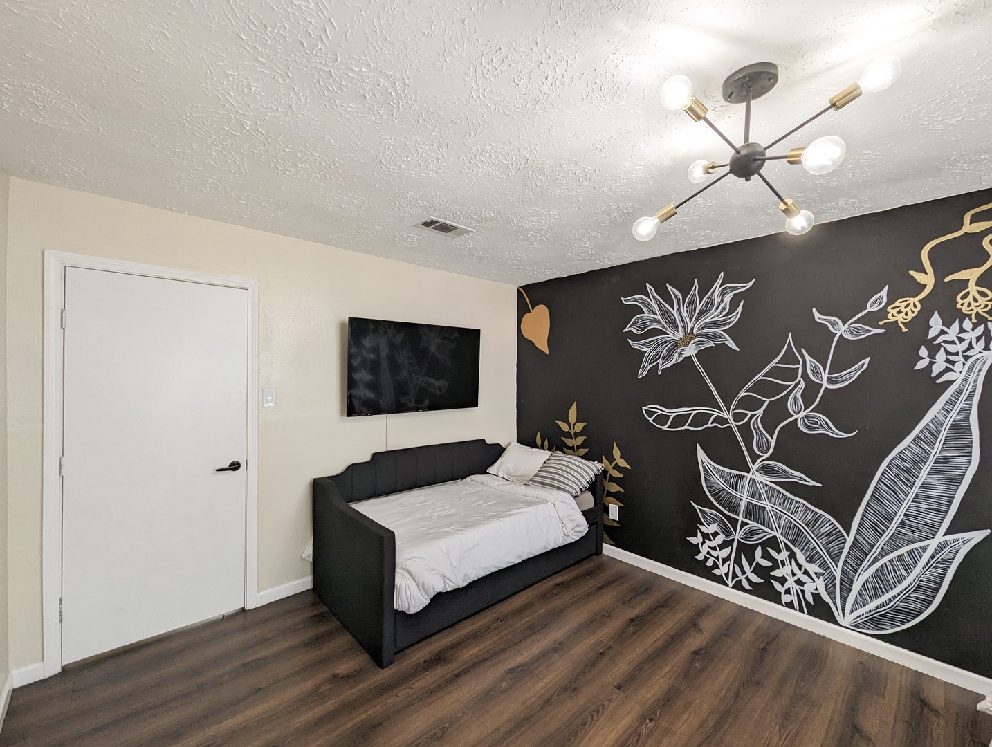 The master suite features a Smart TV, private ensuite, king bed, twin bed & trundle