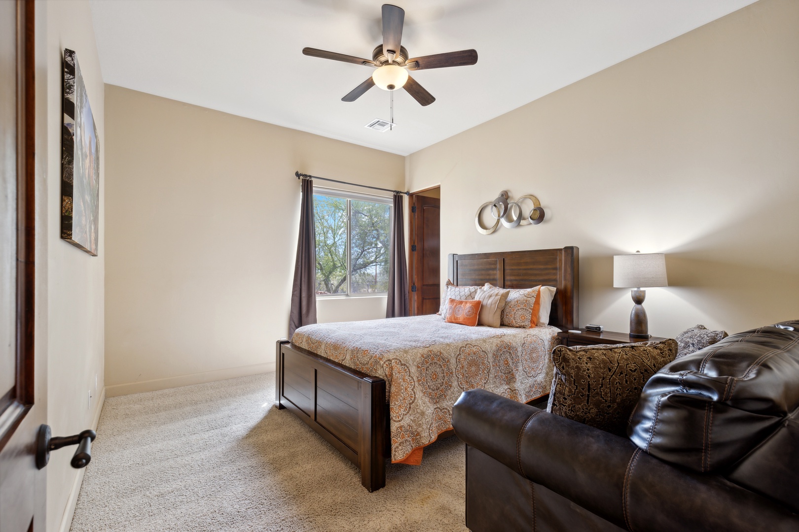 This bedroom includes a comfy queen bed & couch