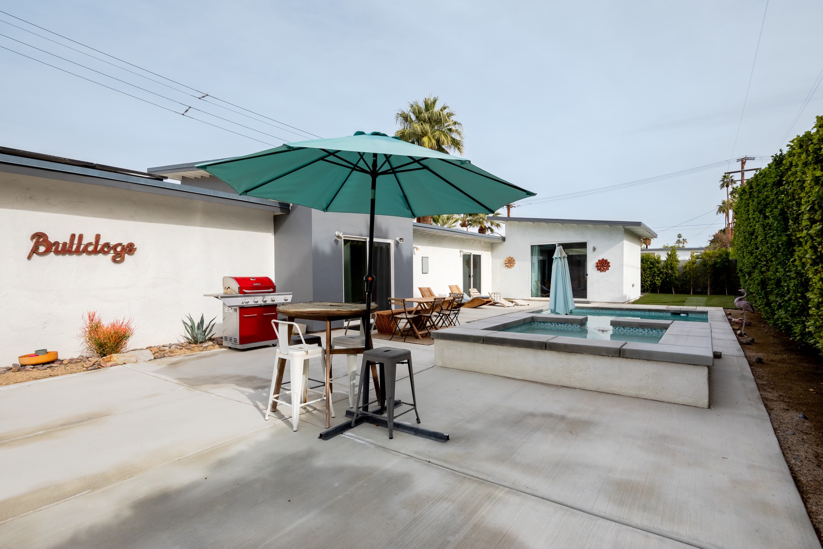 Outdoor dining with umbrella by the pool