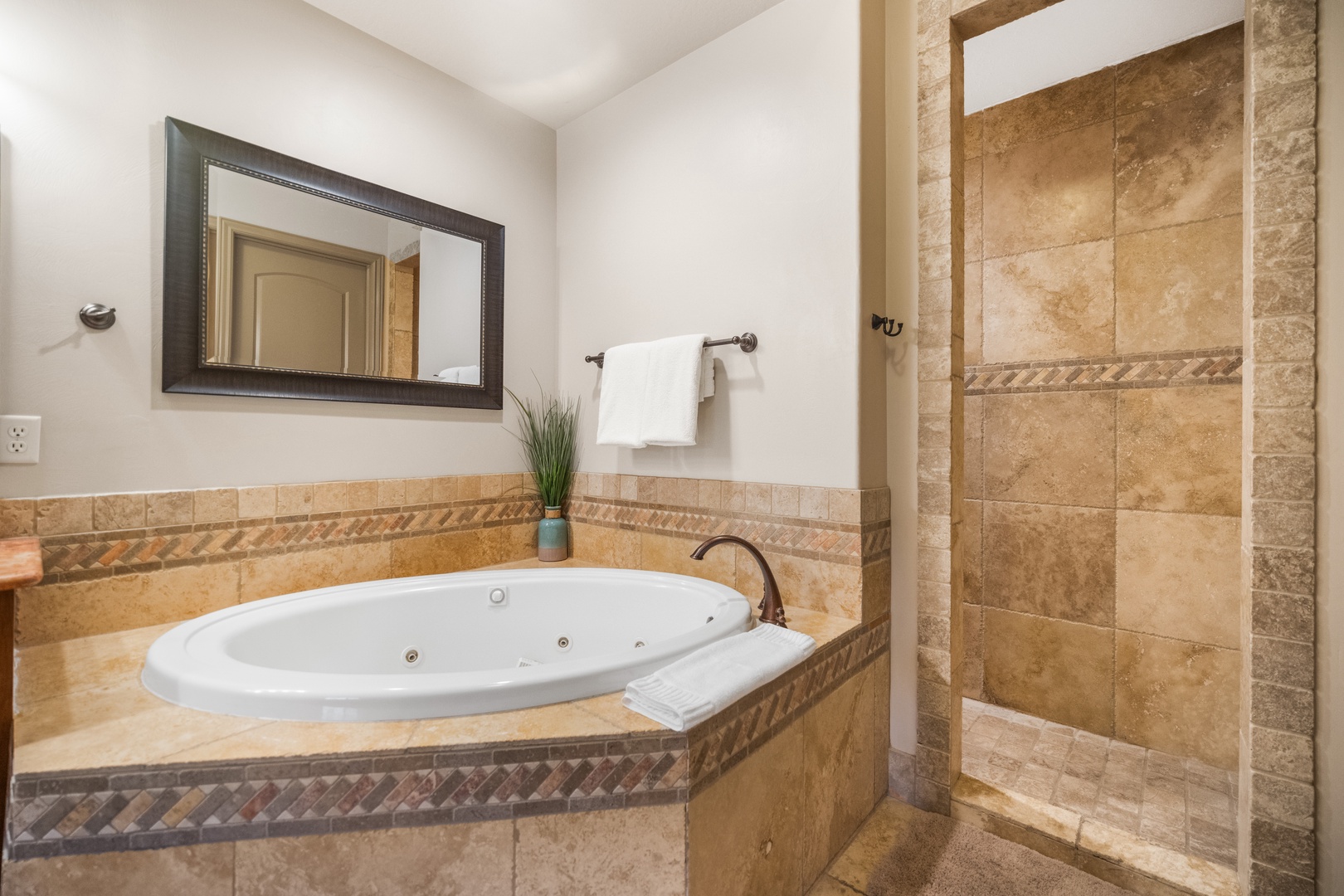 The primary ensuite showcases a dual sink, soaking tub & walk-in shower