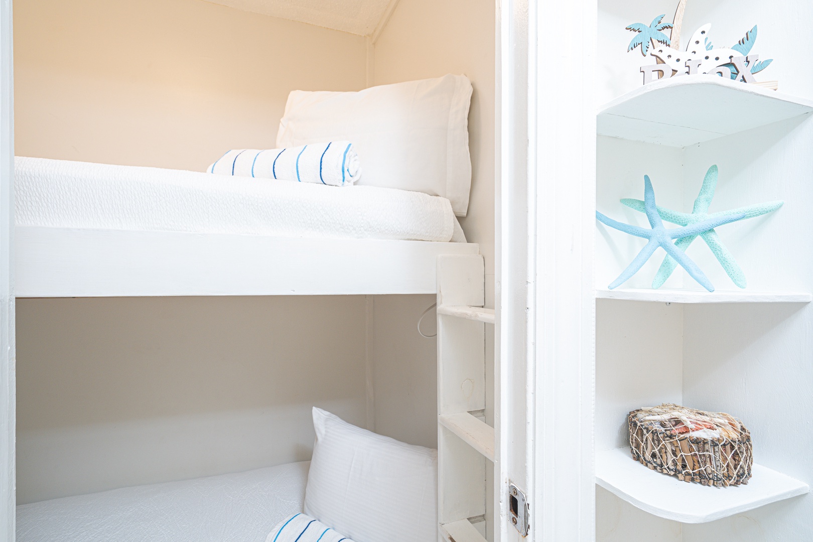 A cozy nook by the entryway offers twin-over-twin bunkbeds