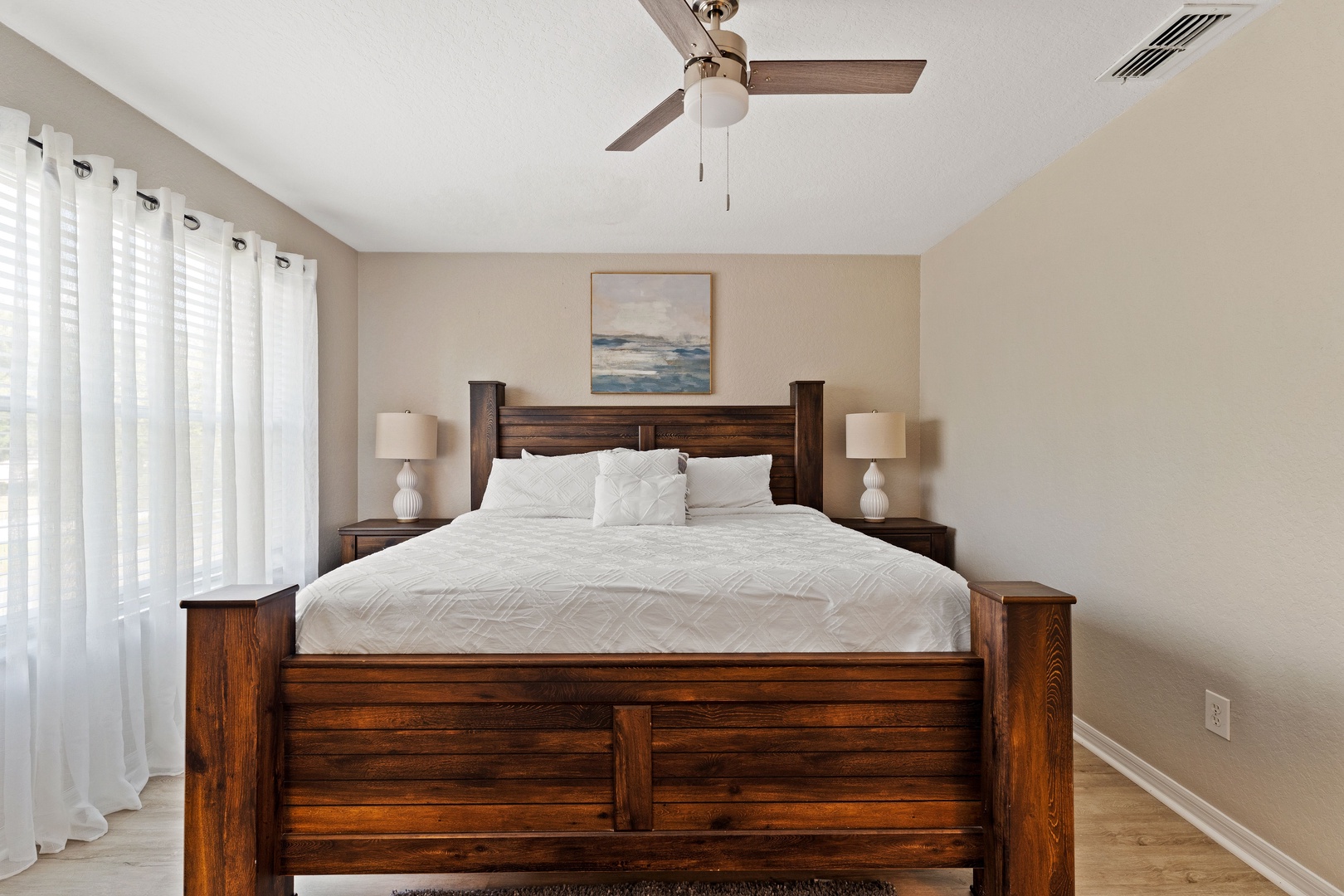 The king suite boasts a private en suite, TV, & ceiling fan