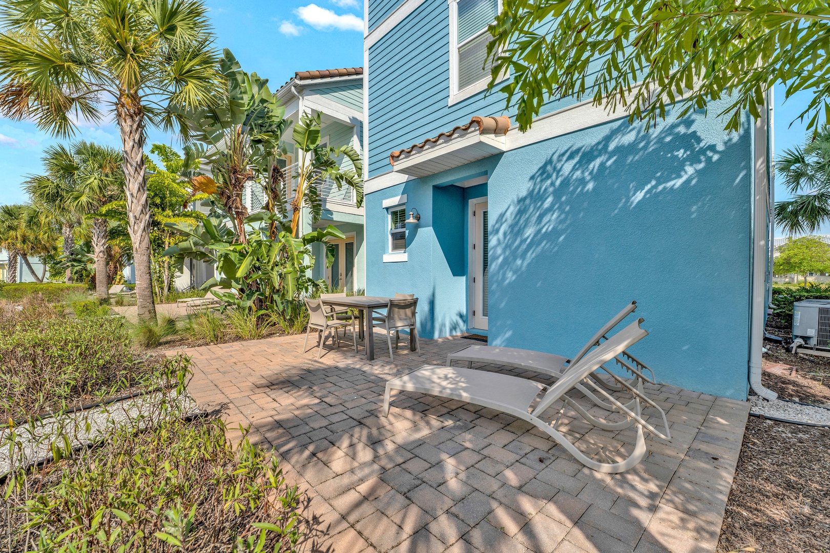 Soak up the sun on the private patio, surrounded by lush tropical landscaping