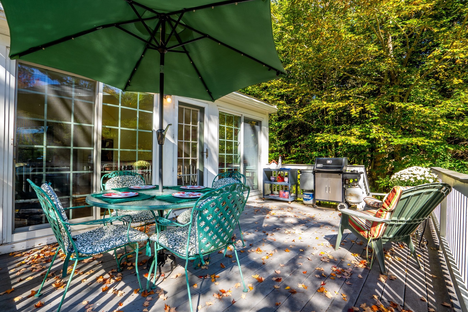 Spacious deck with outdoor seating and grill