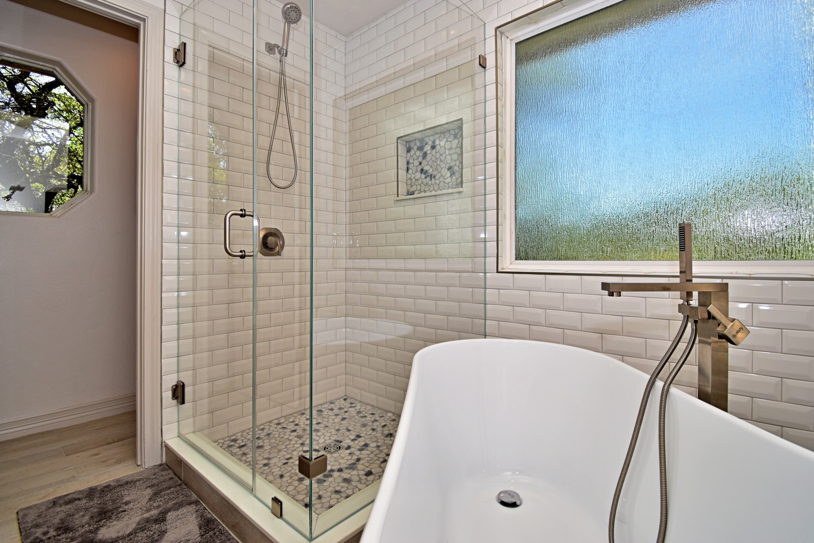 The king ensuite features a dual vanity, glass shower, & luxurious soaking tub
