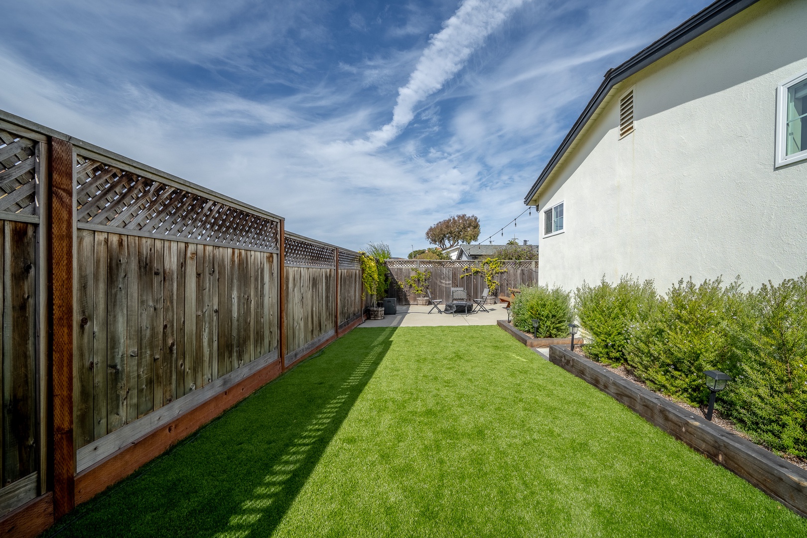 The private back yard offers ample space for relaxation, dining, & play