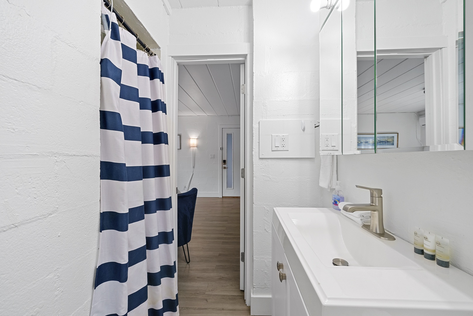 A single vanity & shower await in the serene full bathroom