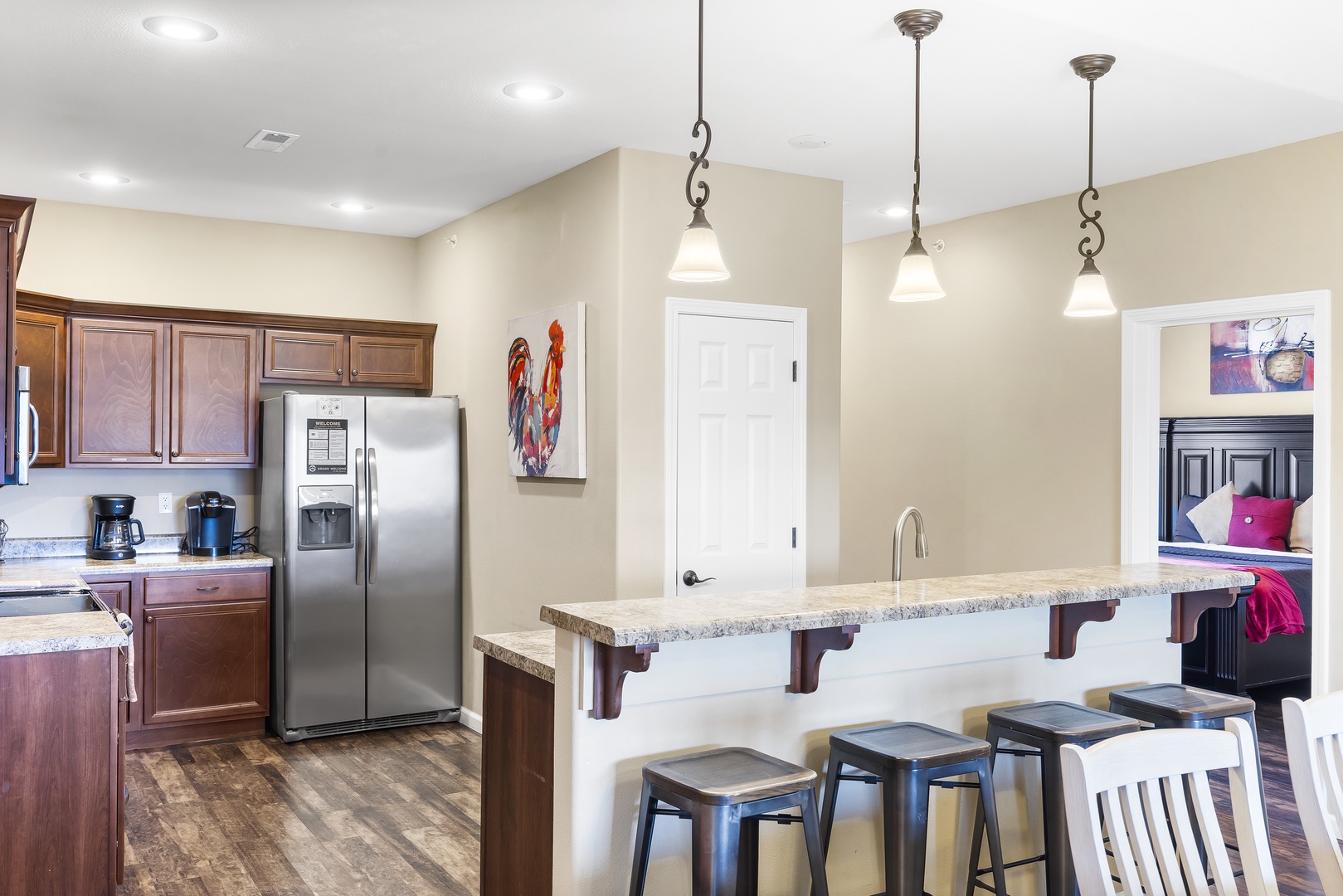 The chic, airy kitchen offers ample space & all the comforts of home