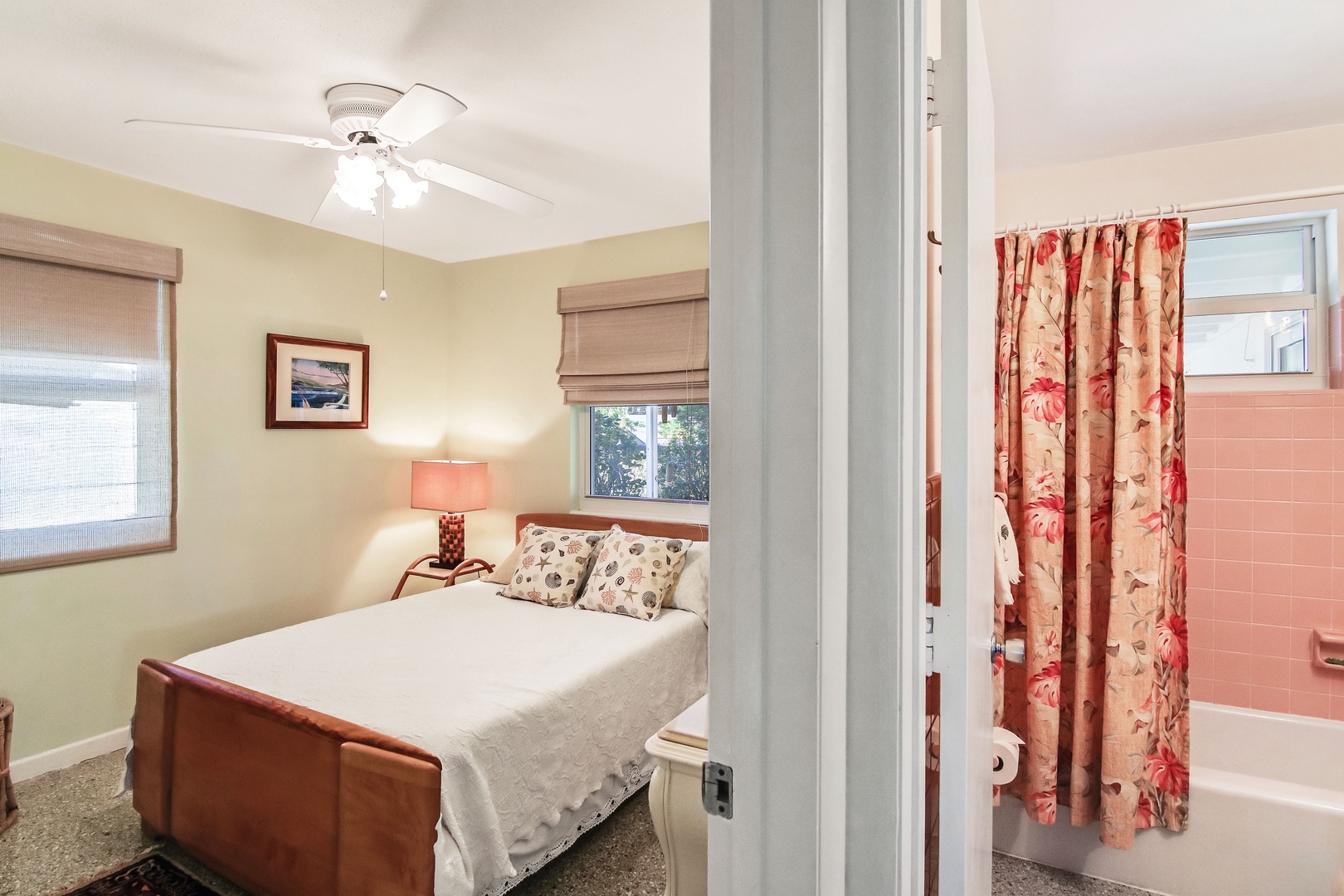The first of two additional bedrooms, showcasing a plush queen-sized bed