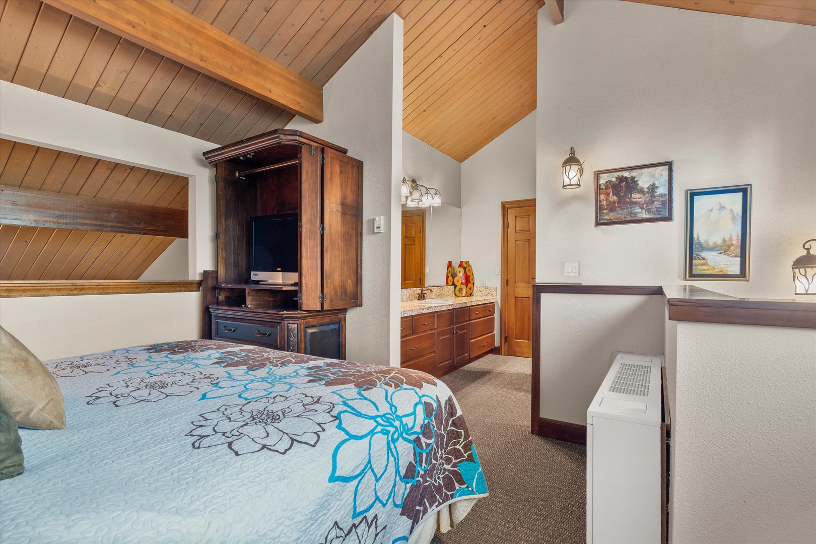 The upper-level loft offers a king bed & ensuite bath