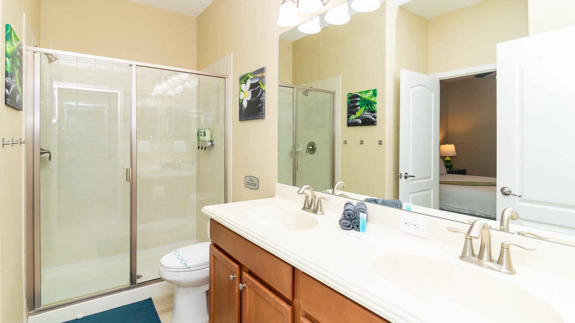 A double vanity & glass walk-in shower await in this Jack & Jill bath