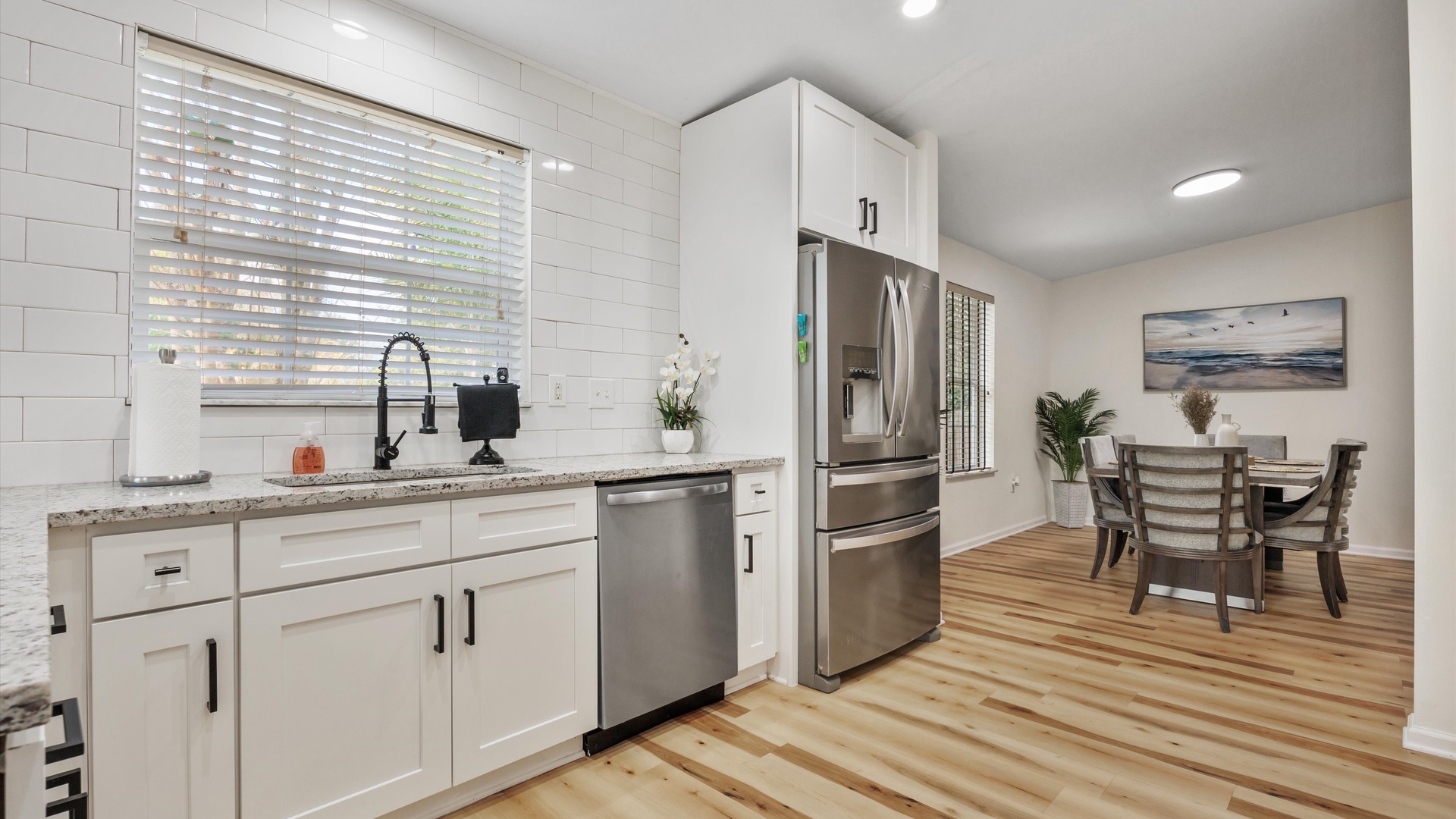 The airy, updated kitchen offers ample space & all the comforts of home