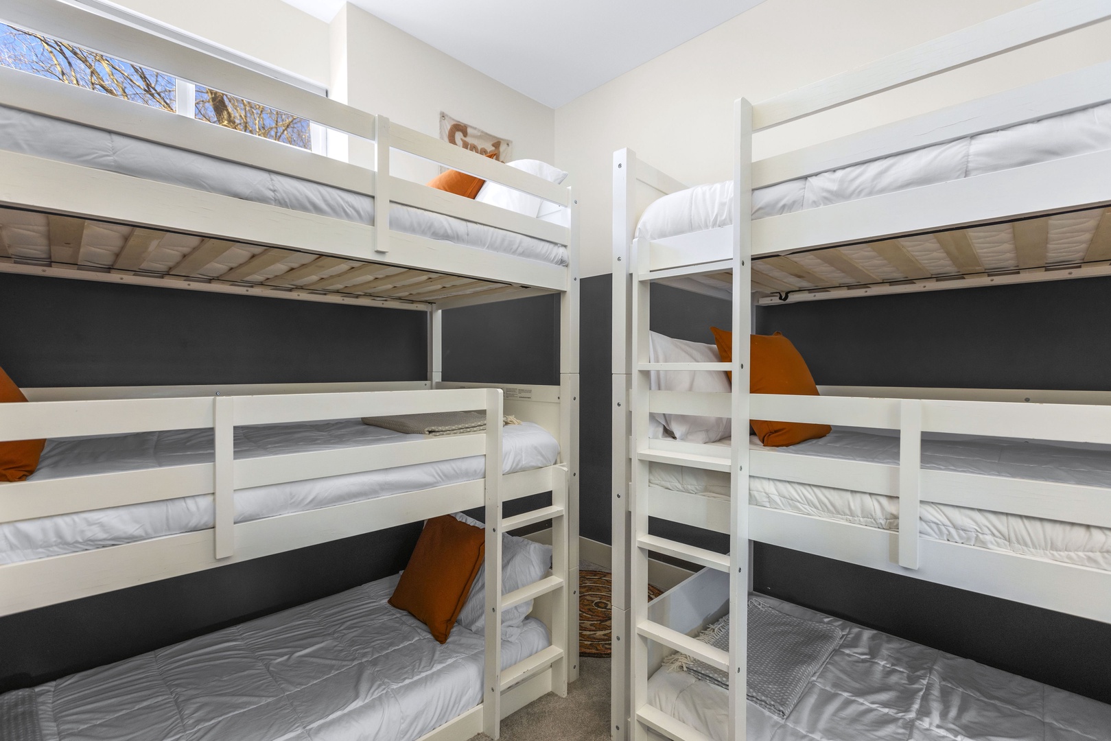 The second bedroom includes a pair of triple twin bunkbeds