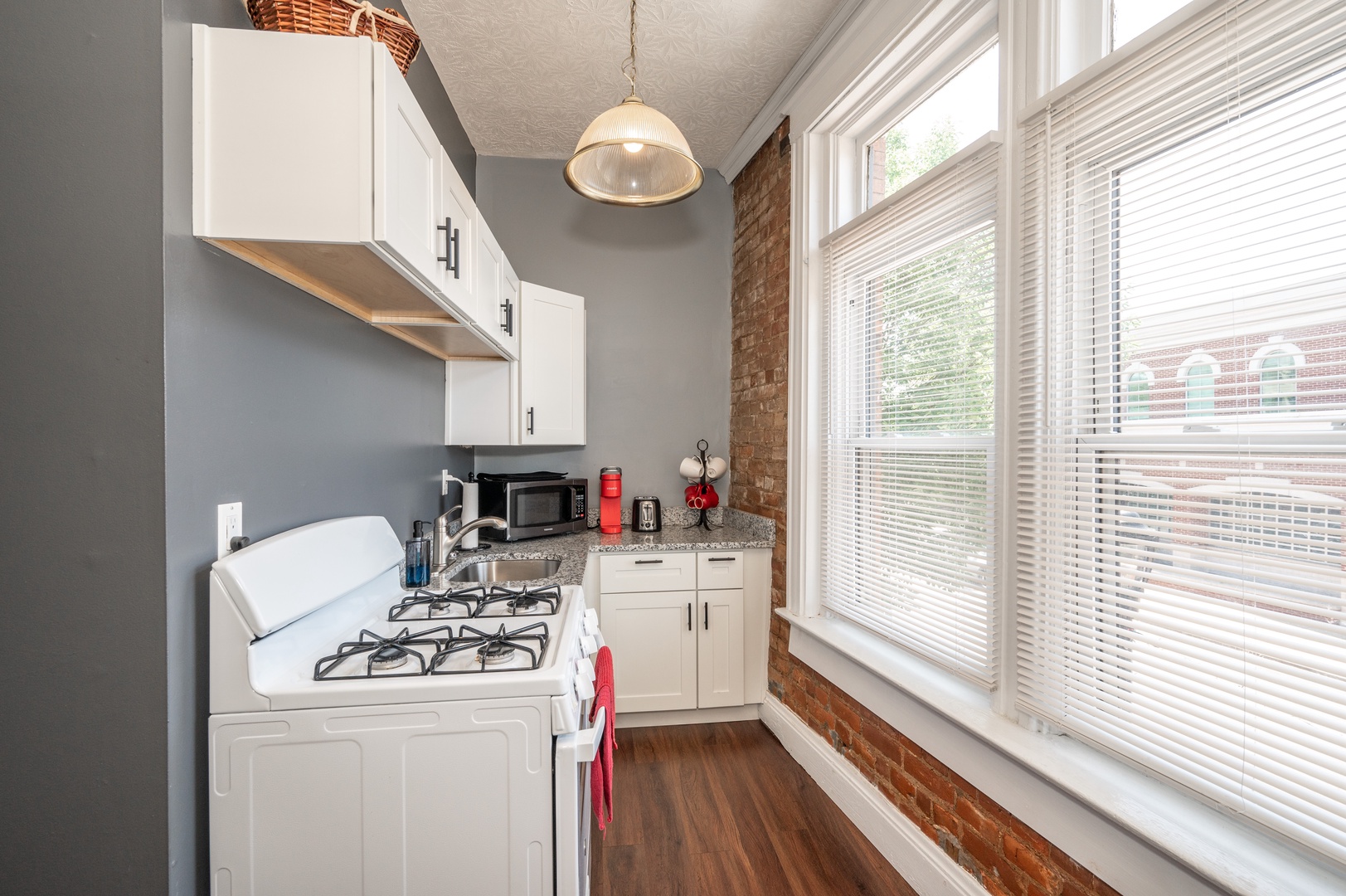 Enjoy the comforts of home & historic exposed brick of the kitchen