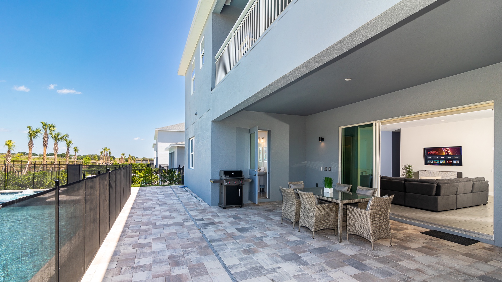 Shaded lanai with outdoor dining and grill allows for delicious poolside meals with the whole group