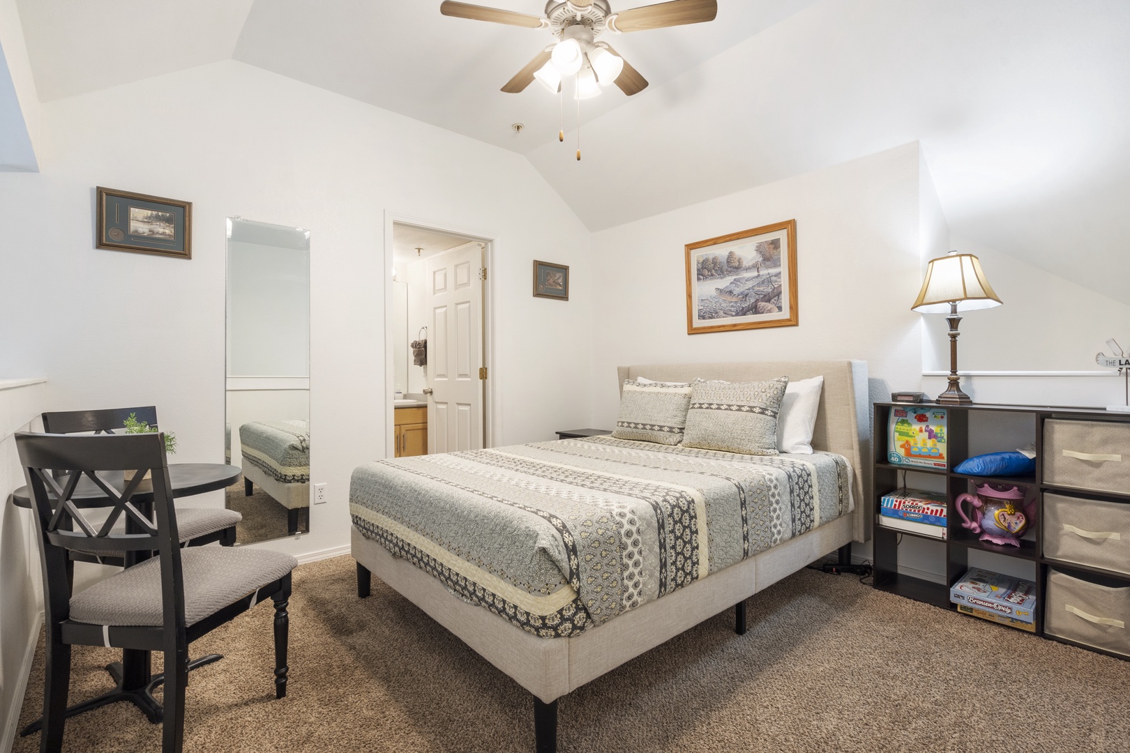 The loft bedroom features a queen bed, sitting area with games, & ensuite