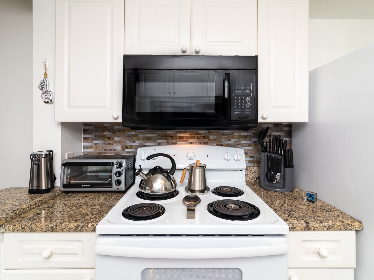 Fully equipped kitchen with electric stove