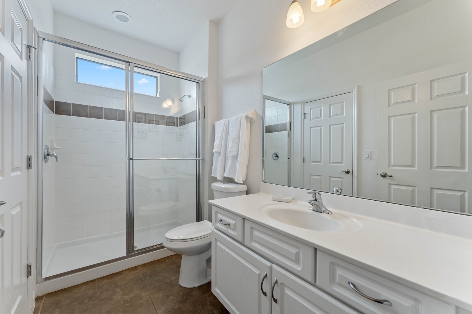 Bathroom 1 shared en-suite with walk-in shower accessible from living area (1st floor)