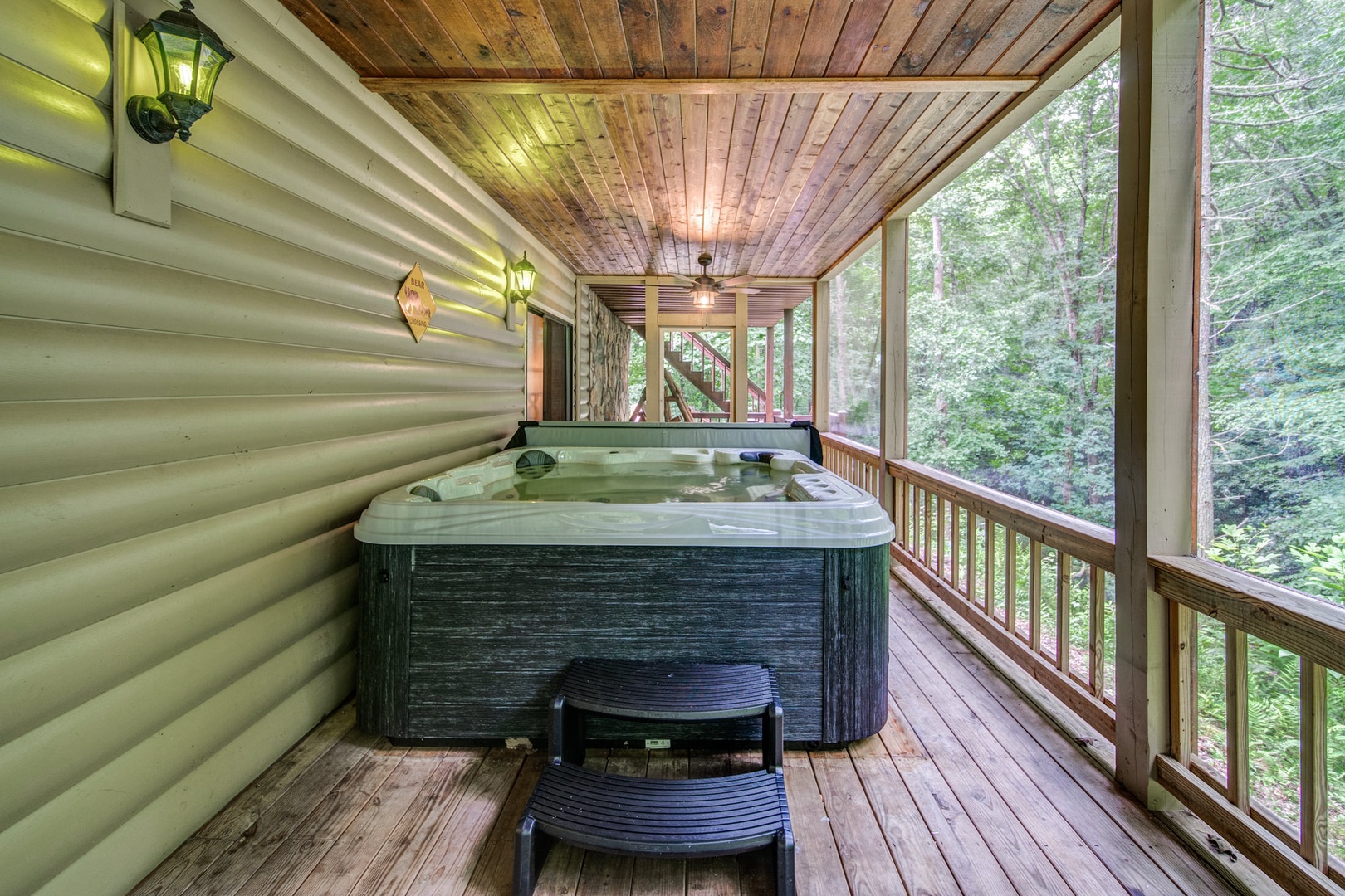 Soak away the stress with views of the running creek and private waterfall next to the woods