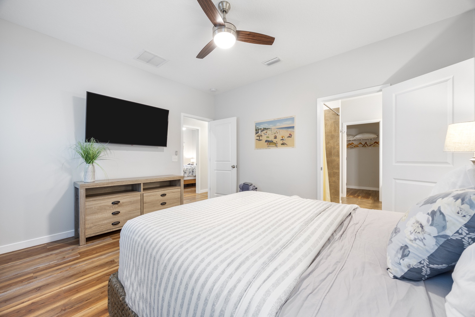 The master suite boasts a queen bed, smart TV, & luxe private ensuite