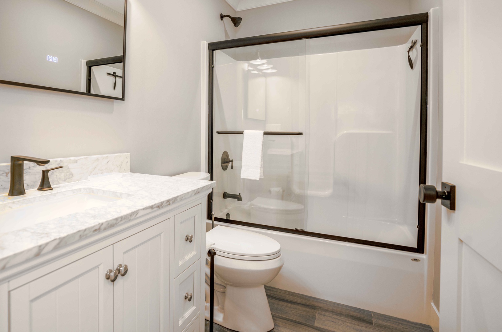 The second full bath includes a single vanity & shower/tub combo